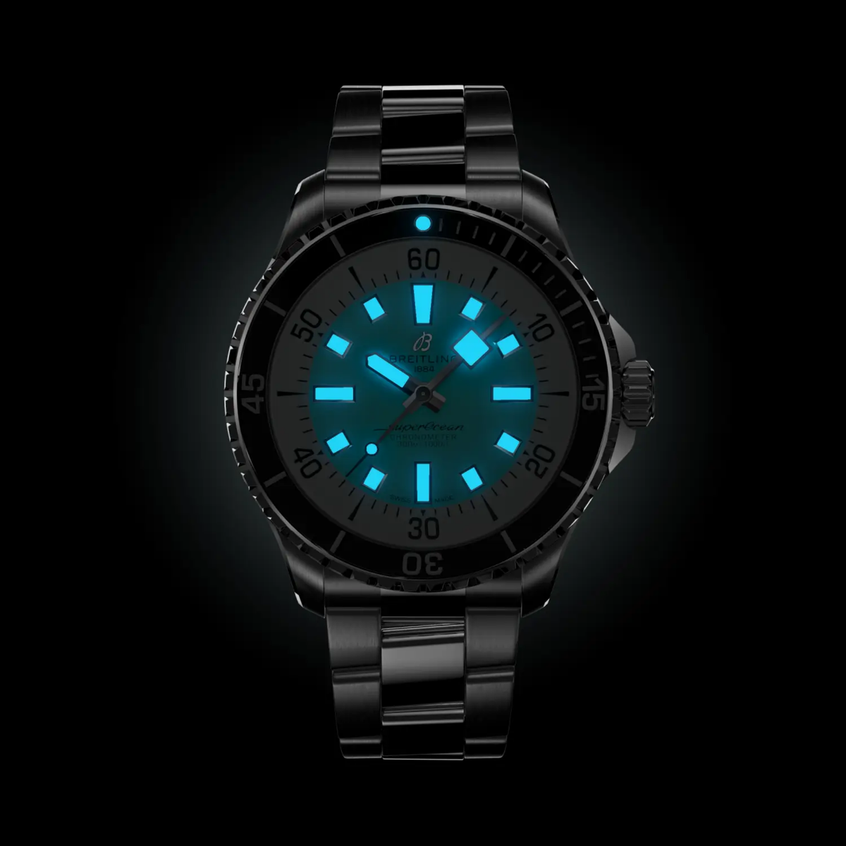 Breitling Superocean turquoise dial diver watch worn on wrist with stainless steel bracelet