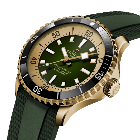 side view of Breitling Superocean gold case with fluted bezel and green rubber strap detail