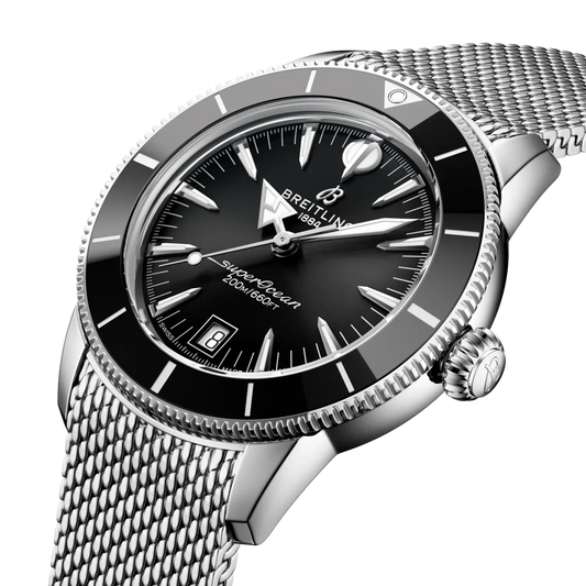 side view of Breitling Superocean Heritage stainless steel case black ceramic bezel mesh bracelet detail