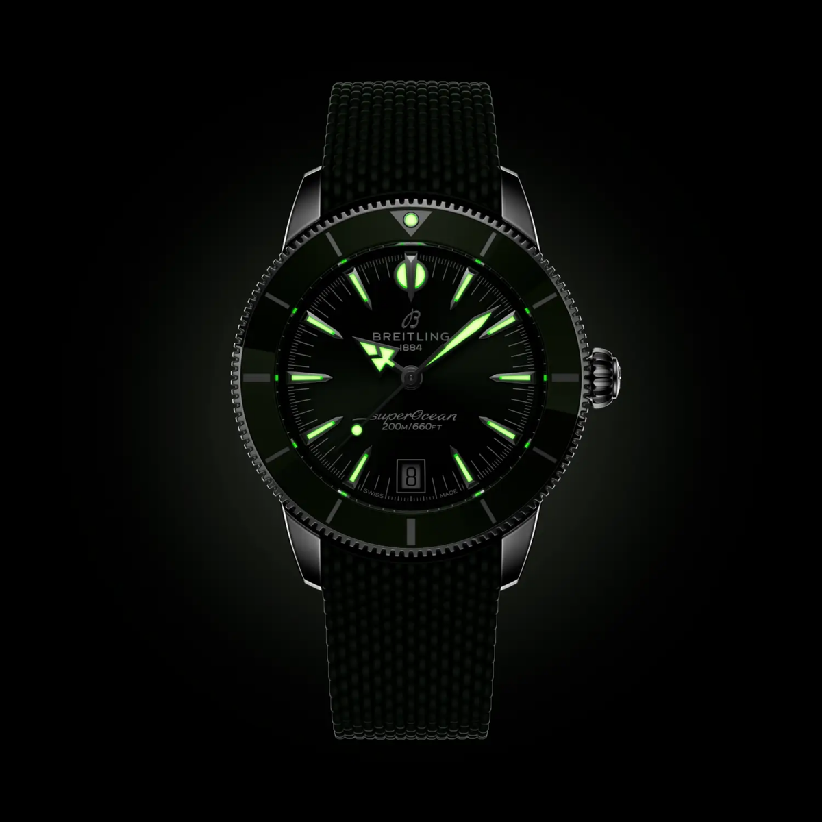 Breitling Superocean green dial watch glowing in the dark with luminous hands and hour markers for reliable low-light visibility
