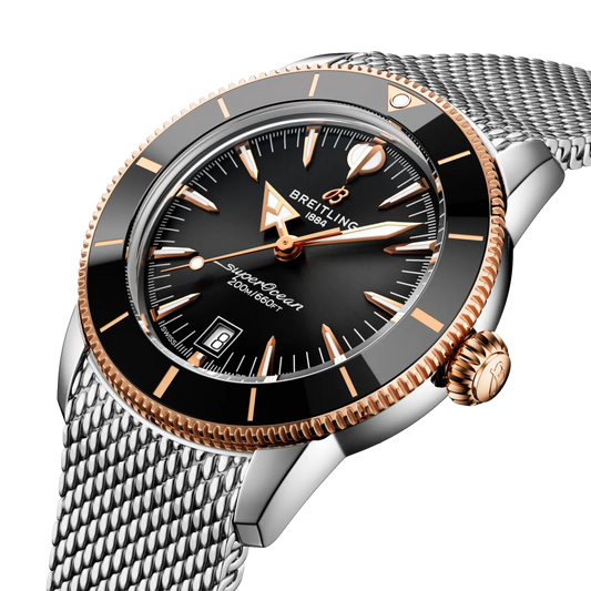 side view of Breitling Superocean Heritage two tone case rose gold bezel edge crown detail mesh bracelet