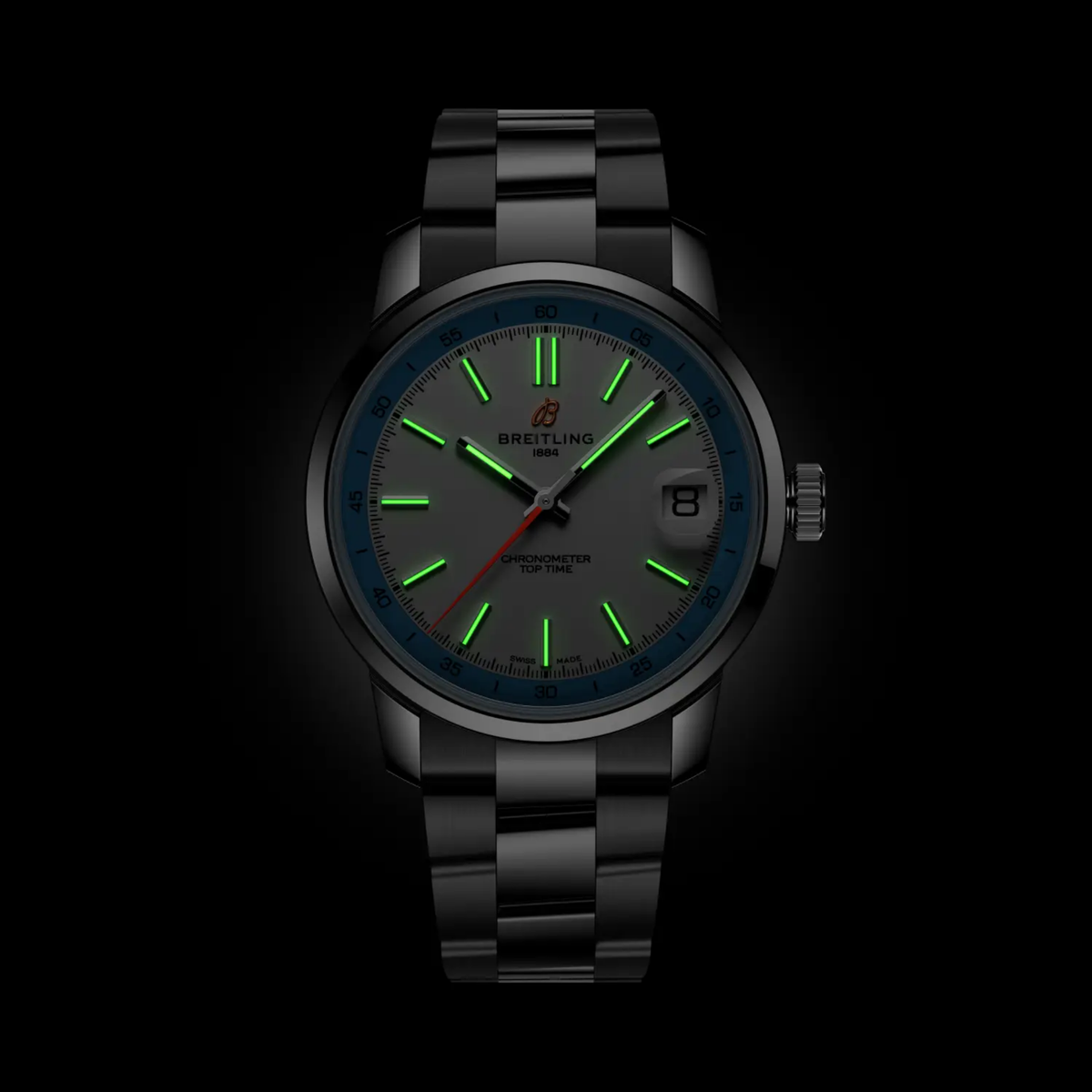 Breitling Top Time white dial watch glowing in the dark with luminous hands and hour markers for enhanced night-time readability