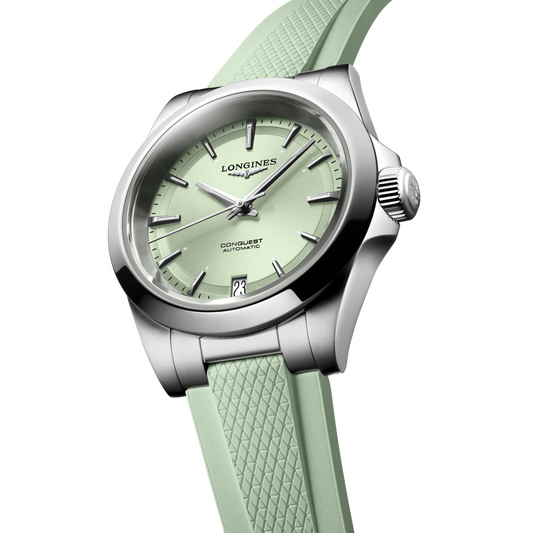 close up of the Longines Conquest sunray green dial featuring polished silver hands, applied markers and date display
