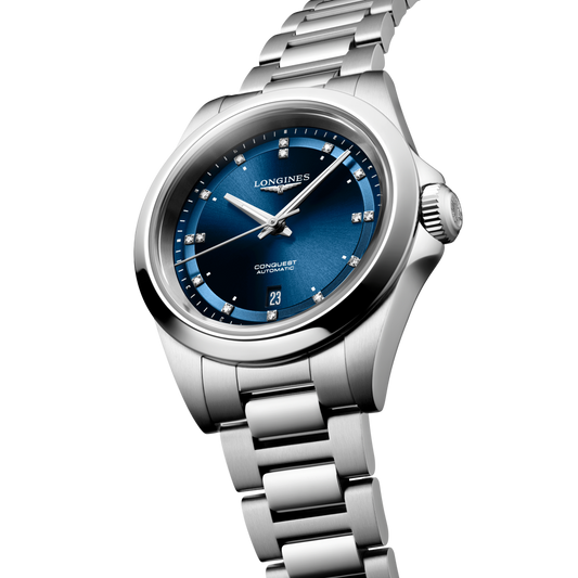 close up of the Longines Conquest blue sunray dial featuring diamond hour markers, silver hands and date display

