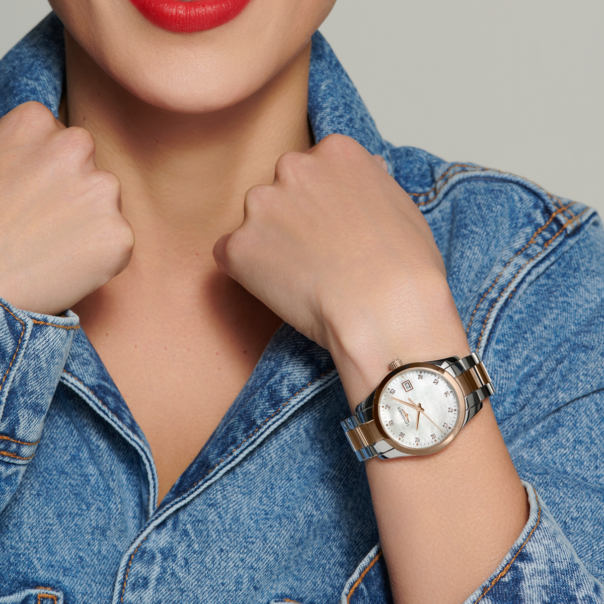 Longines Conquest two tone watch worn on the wrist featuring a mother of pearl dial and elegant rose gold details
