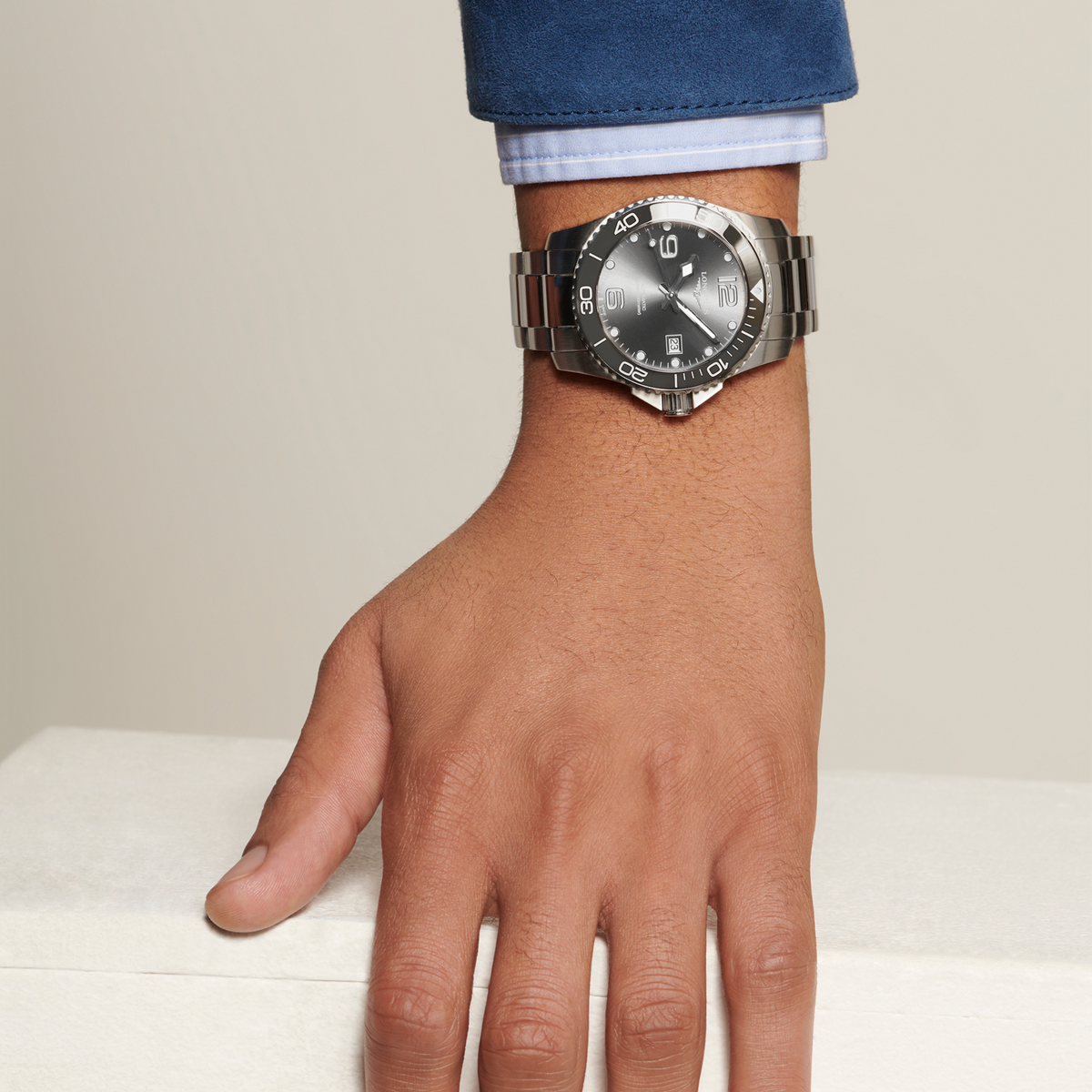 Longines HydroConquest diver’s watch worn on the wrist with sporty black dial and stainless steel bracelet design
