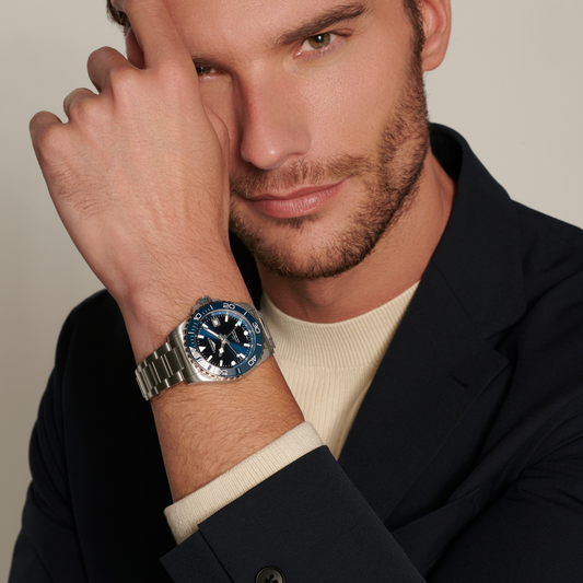 Longines HydroConquest GMT watch worn on the wrist featuring a deep blue dial, matching ceramic bezel and sporty steel bracelet
