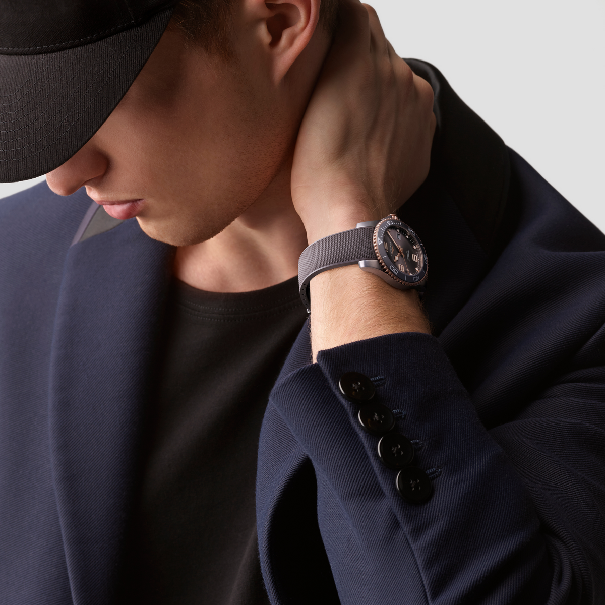 Longines HydroConquest two tone sports watch worn on the wrist with a grey mesh strap and rose gold detailing
