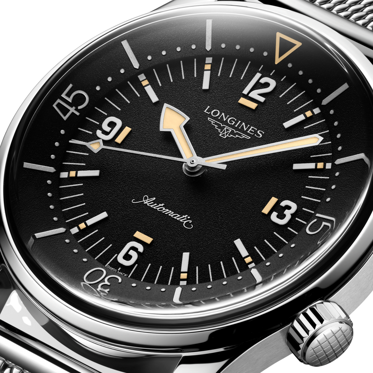 Longines Legend Diver watch worn on the wrist with a stainless steel mesh bracelet and retro dive watch styling
