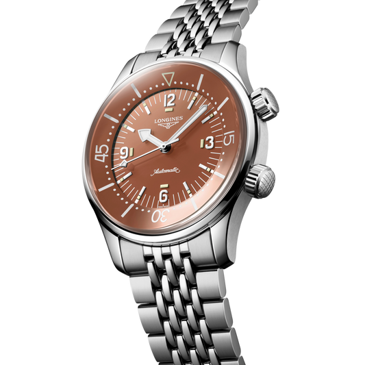 close up of the Longines Legend Diver bronze dial featuring luminous markers, internal rotating bezel and oversized Arabic numerals

