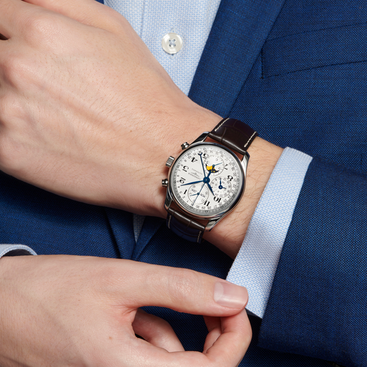 lifestyle image of Longines Master Collection moonphase watch worn on a wrist showcasing the silver dial and brown leather strap
