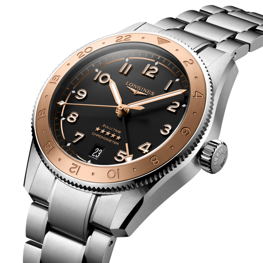 side view of Longines GMT watch case, crown and brushed stainless steel profile with rose gold-tone bezel detail
