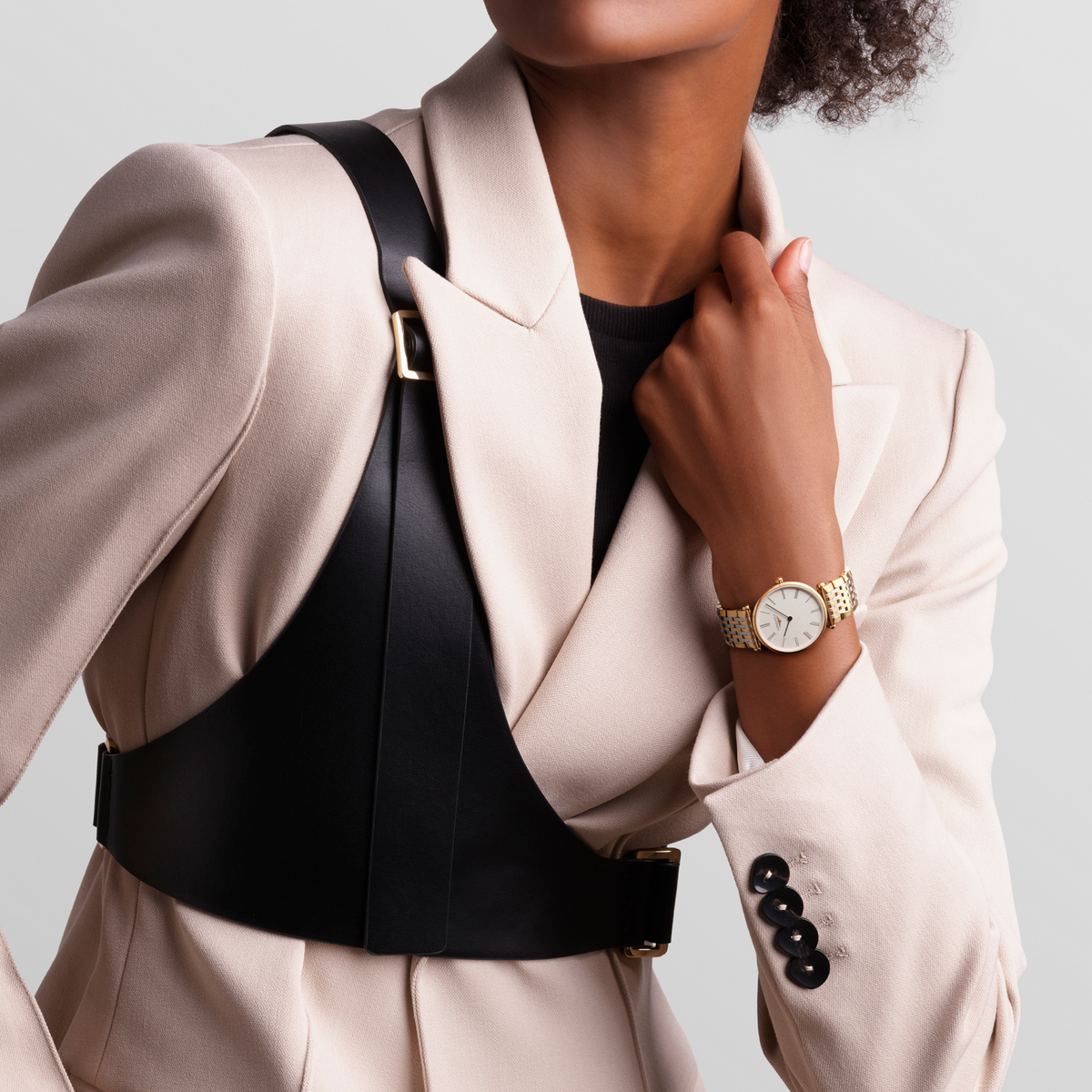 Longines La Grande Classique dress watch worn on the wrist with a gold tone bracelet and elegant white dial styling
