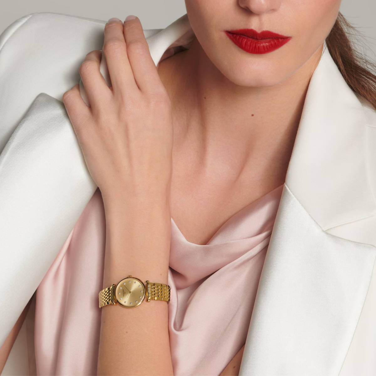 Longines La Grande Classique gold tone dress watch worn on the wrist with sparkling diamond set dial details
