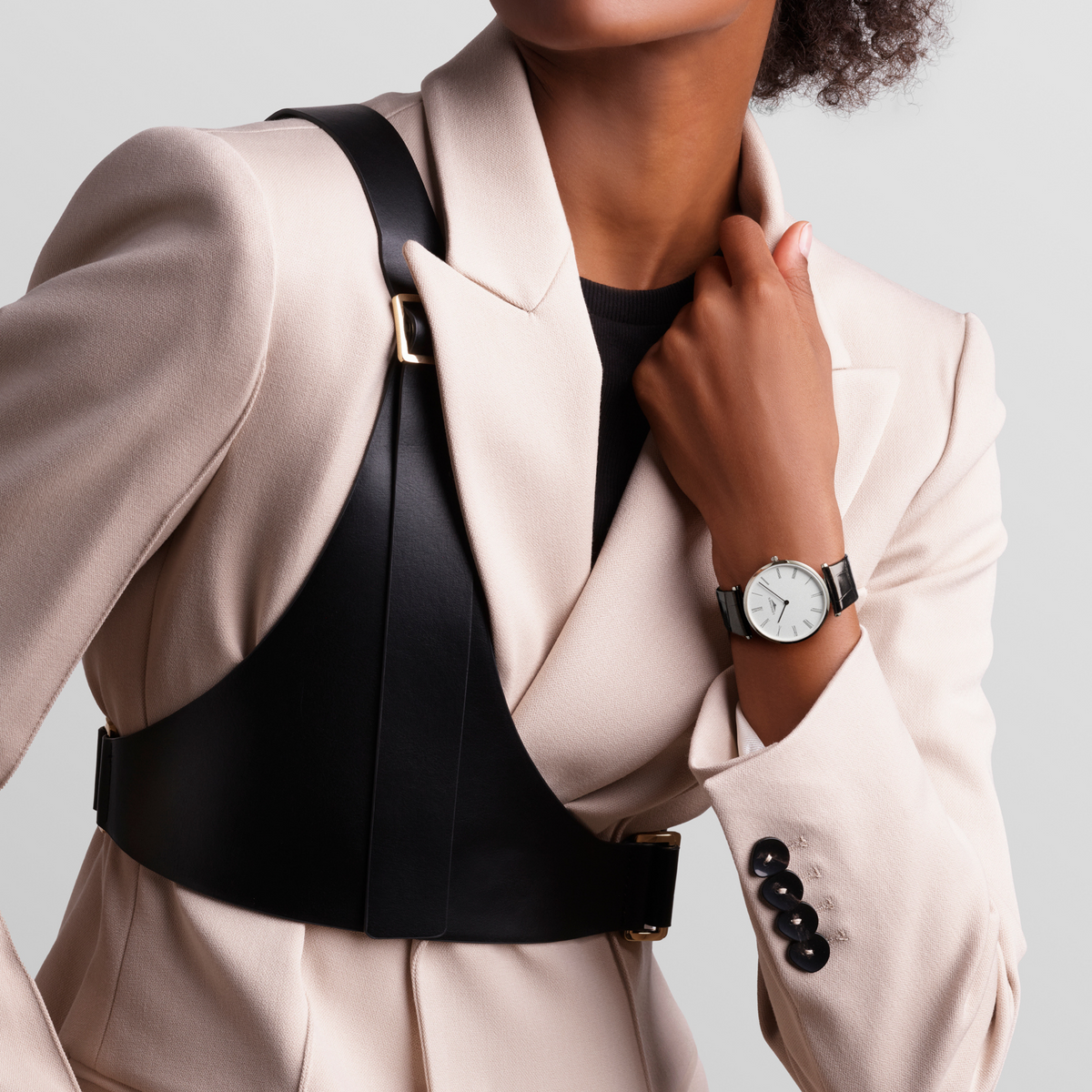 Longines La Grande Classique dress watch worn on the wrist with a black leather strap and minimalist white dial styling
