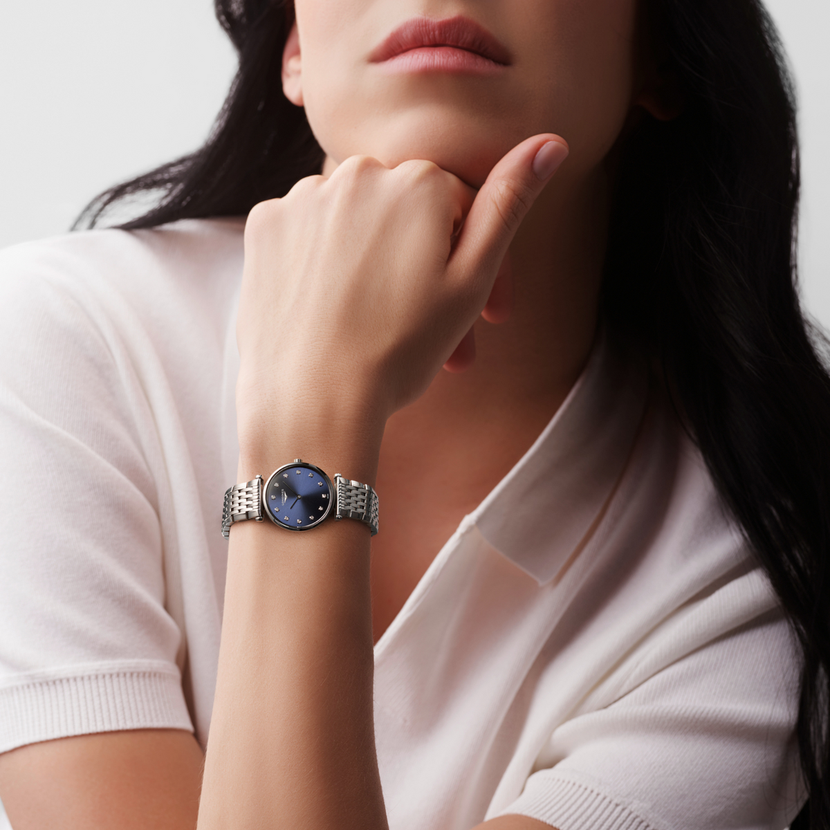 Longines La Grande Classique blue dial dress watch worn on the wrist with a polished stainless steel bracelet
