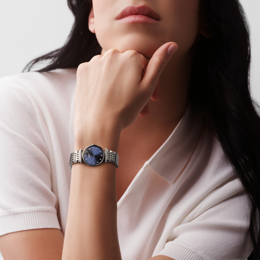 Longines La Grande Classique blue dial dress watch worn on the wrist with a polished stainless steel bracelet
