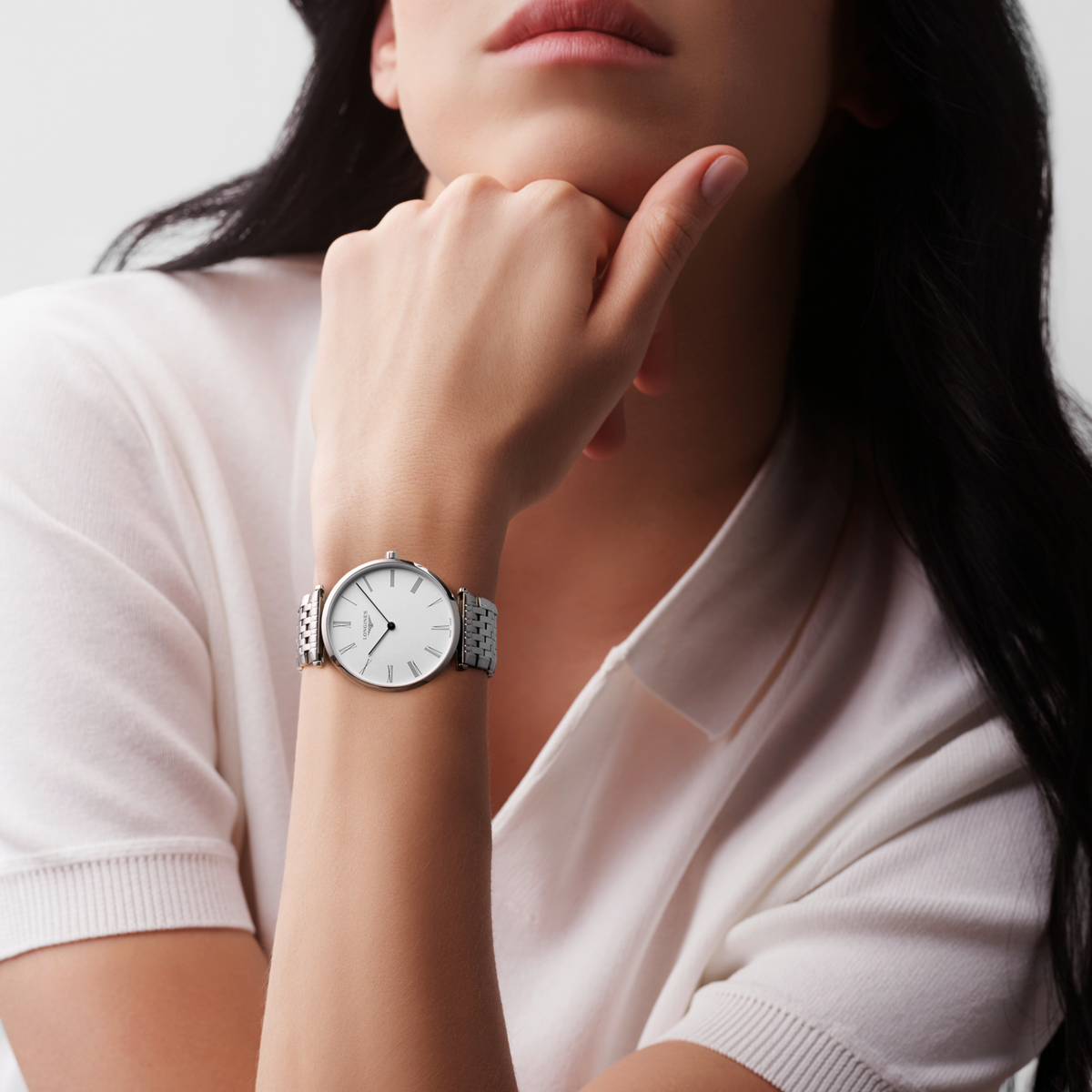 Longines La Grande Classique white dial dress watch worn on the wrist with an elegant stainless steel bracelet
