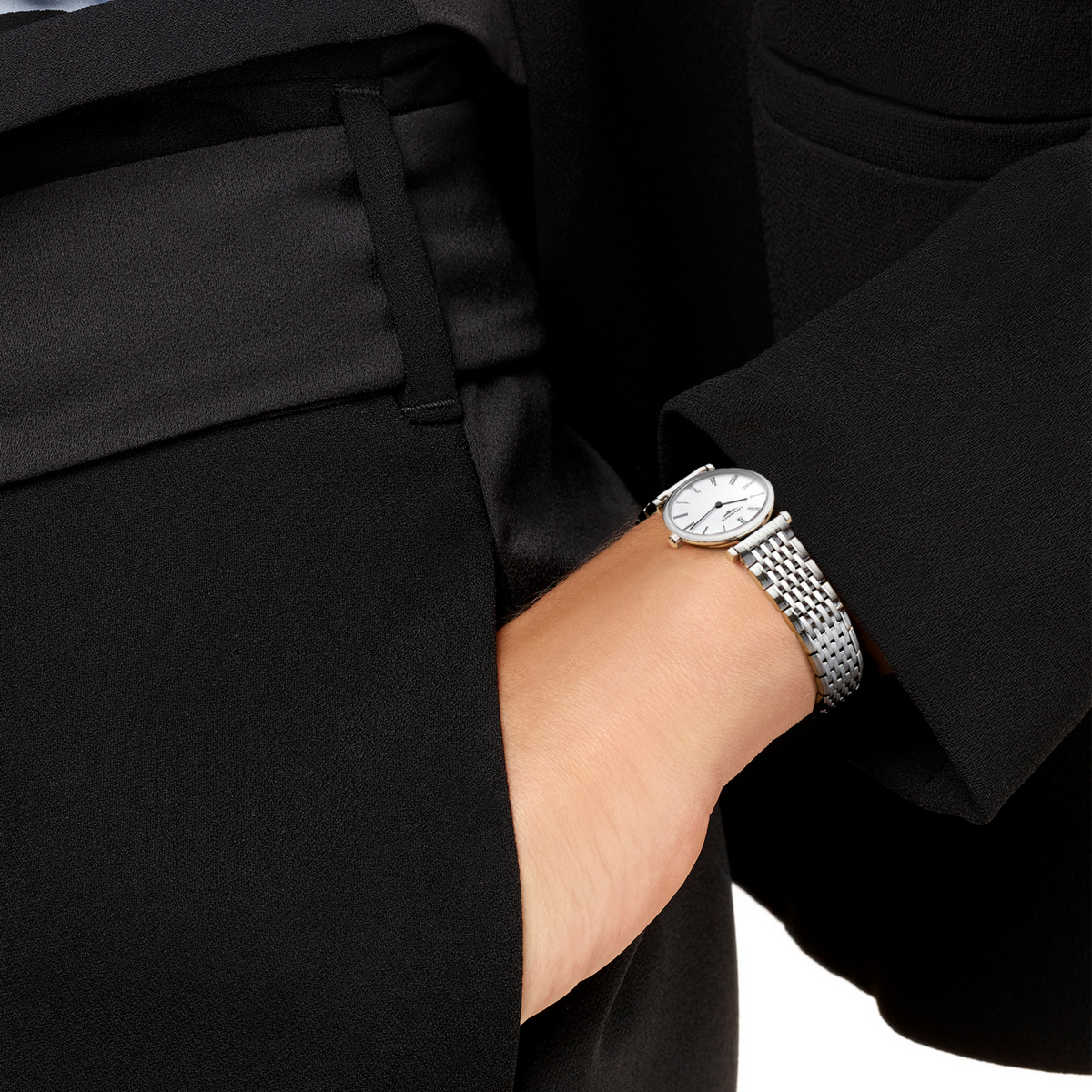 Longines La Grande Classique white dial dress watch worn on the wrist with a polished stainless steel bracelet
