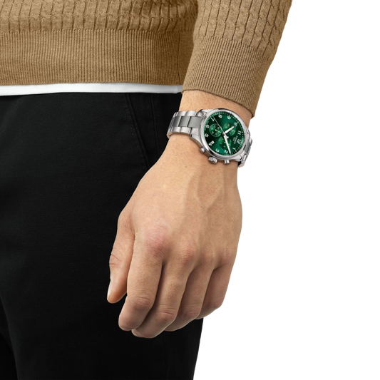 the watch worn on the wrist, showcasing the substantial stainless steel case, chronograph sub-dials, and vibrant green dial suited to everyday wear and casual sporty styling
