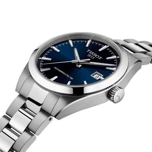 angled front-side image of the watch on the bracelet, emphasising the sunburst blue dial effect, polished hour markers, and the contrast between brushed and polished steel surfaces from a dynamic perspective