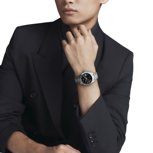 Swiss automatic Tissot Gentleman featuring a black dial and polished steel bracelet.