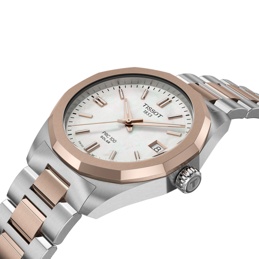 angled view of the watch on the bracelet, revealing the subtle silver dial texture, warm rose gold-tone accents, and the clean integrated bracelet design from a side-forward perspective