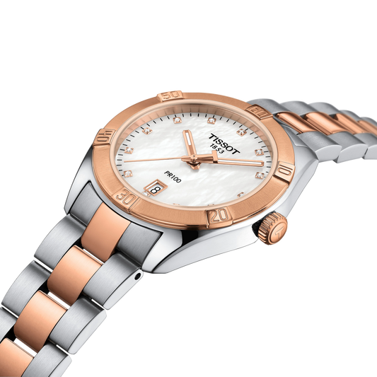 side profile of the case showcasing the brushed and polished stainless steel construction, rose gold-tone bezel detailing, and refined crown finish