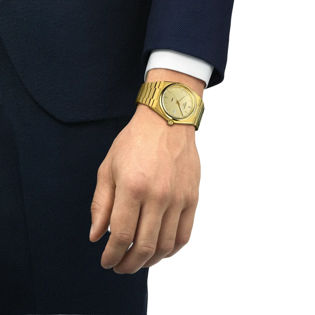 the watch worn on the wrist, showcasing the slim integrated bracelet, streamlined tonneau-shaped case, and monochromatic gold-tone finish suited to statement everyday styling