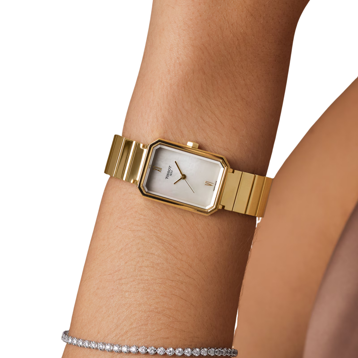 Tissot SRV Quartz 21.8mm, featuring a gold PVD-coated steel case, white mother-of-pearl dial, sapphire crystal and Swiss quartz movement on a model.