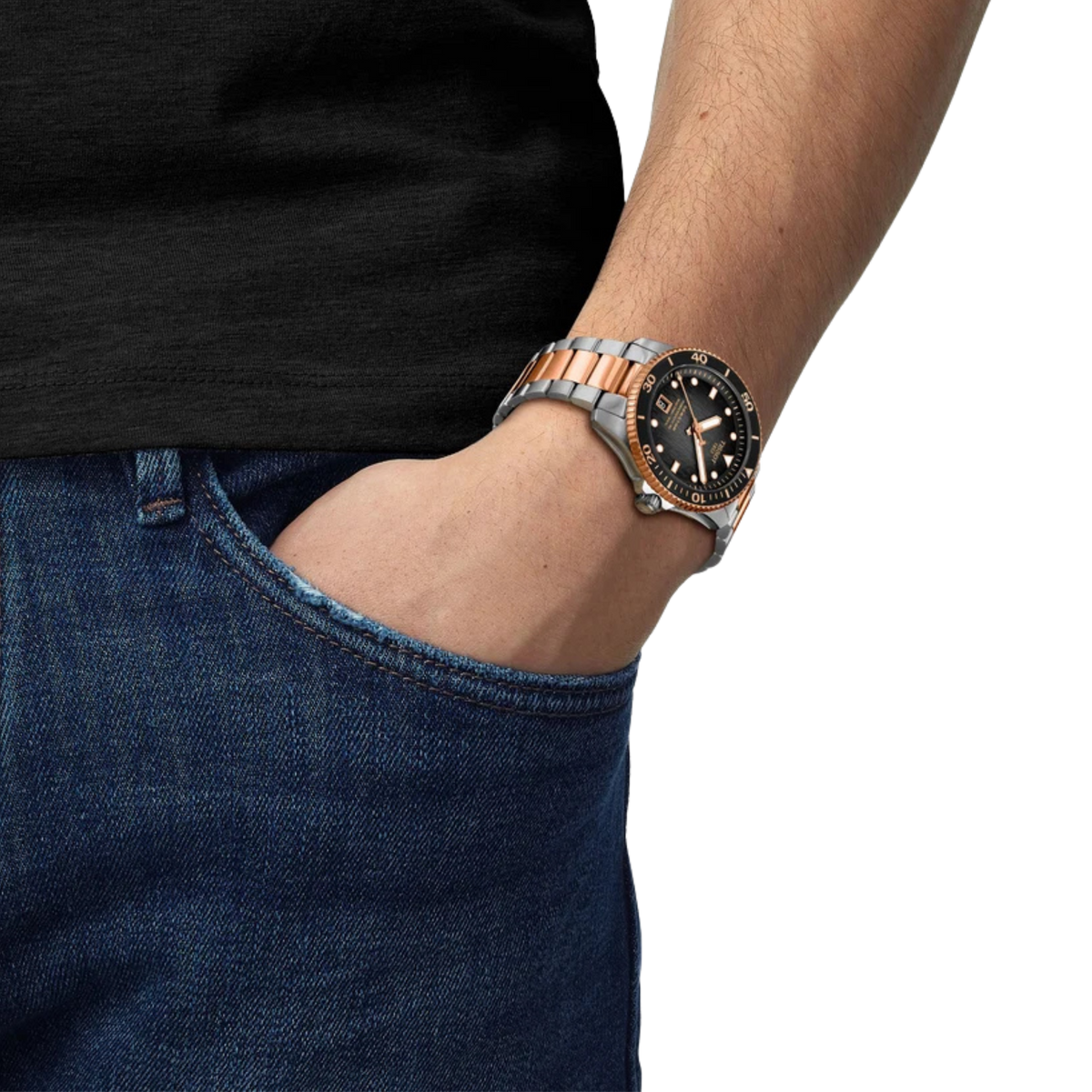 the watch worn on the wrist, showcasing the black textured dial, rose gold-tone accents, and robust two-tone bracelet that create a striking everyday dive-watch presence