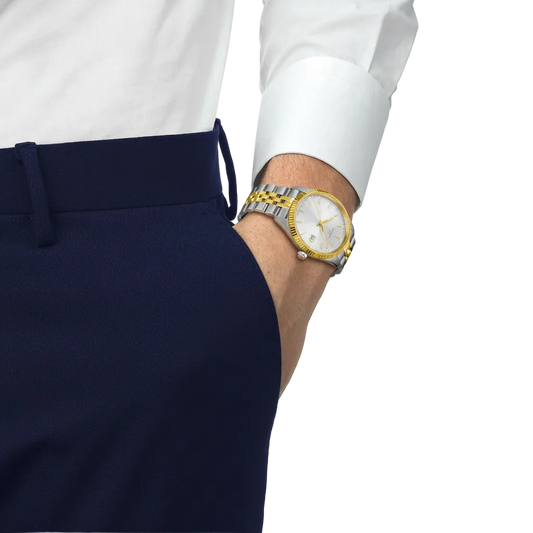 the watch worn on the wrist, showcasing the bright silver dial, gold-tone detailing, and sophisticated two-tone bracelet for a versatile smart-casual look