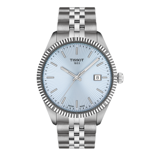 Tissot stainless steel watch featuring a light blue sunburst dial, slim baton hour markers, and a fluted bezel, paired with a polished and brushed steel bracelet for a refined everyday look