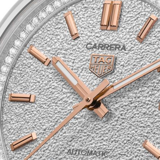 close-up of the silver dial highlighting the grainy textured finish, rose gold-tone indices, handset and date window at 6 o’clock