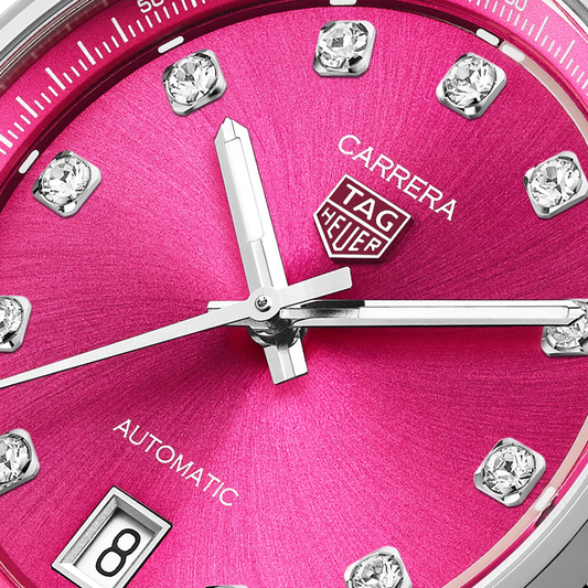 close-up of the pink dial highlighting the sunray finish, diamond hour markers, applied logo and refined handset