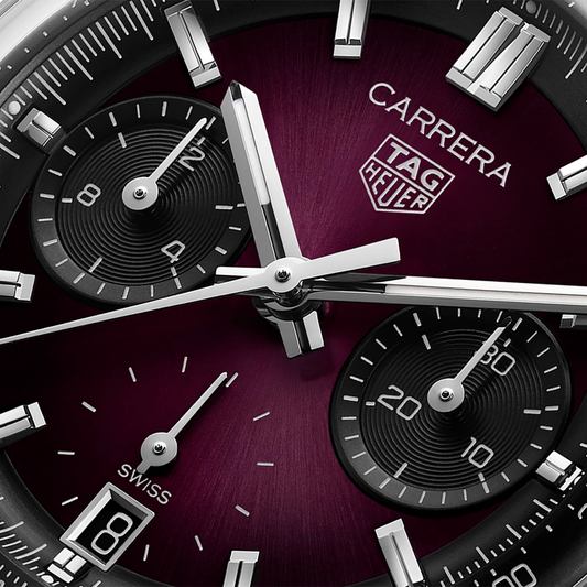 close-up of the red sunray dial highlighting the tri-compax chronograph layout, contrasting black sub-dials, and polished hands and indexes for sharp readability