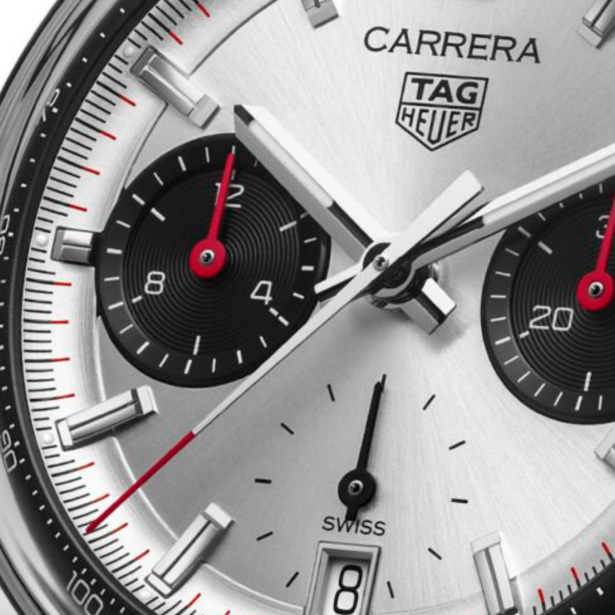 close-up of the silver dial highlighting the sunray finish, black sub-dials, red hands, applied hour markers and detailed minute track