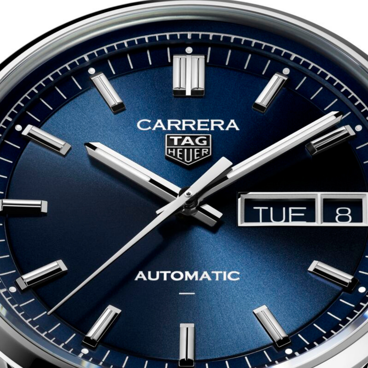 close-up of the blue dial highlighting the sunray finish, applied indices, day-date window and refined handset