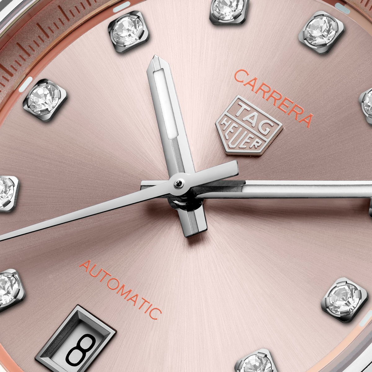 close-up of the pink dial showcasing the sunray finish, diamond hour markers, sleek hands and date window at 6 o’clock