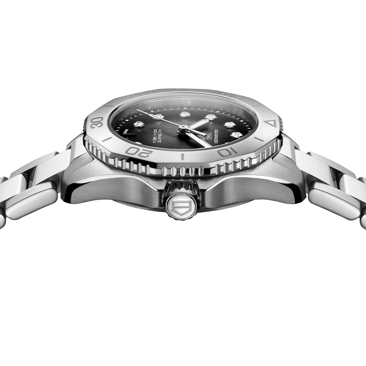 close-up of the black dial highlighting the diamond markers, luminous hands and date window