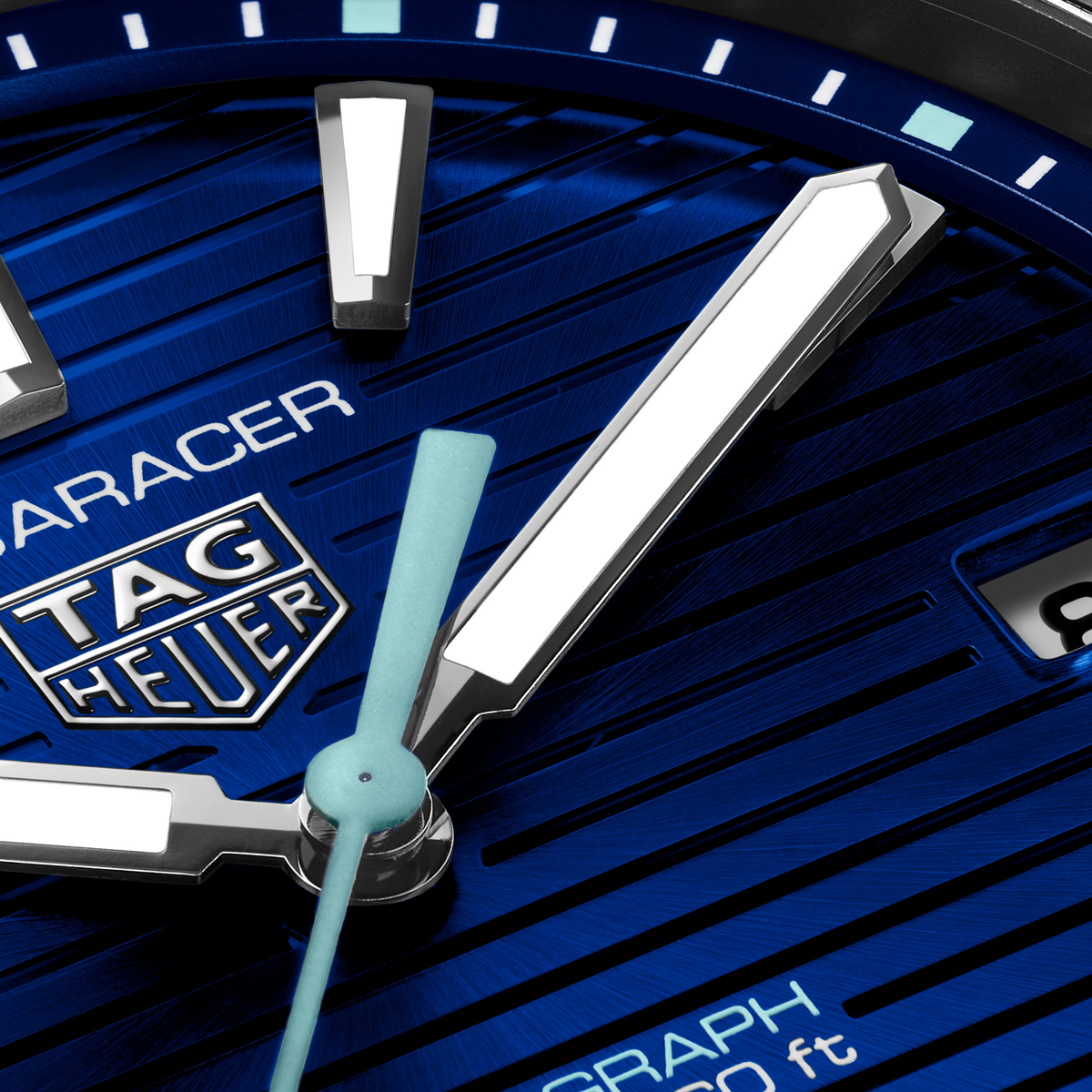close-up of the blue dial showcasing the horizontal stripe texture, luminous hour markers and hands, central seconds hand and date window at 3 o’clock