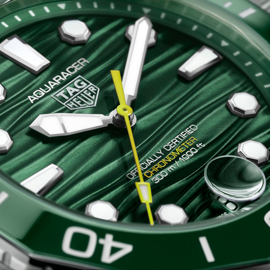 close-up of the rich green dial, highlighting the signature wave texture, high-contrast hands, and yellow seconds hand for enhanced visibility