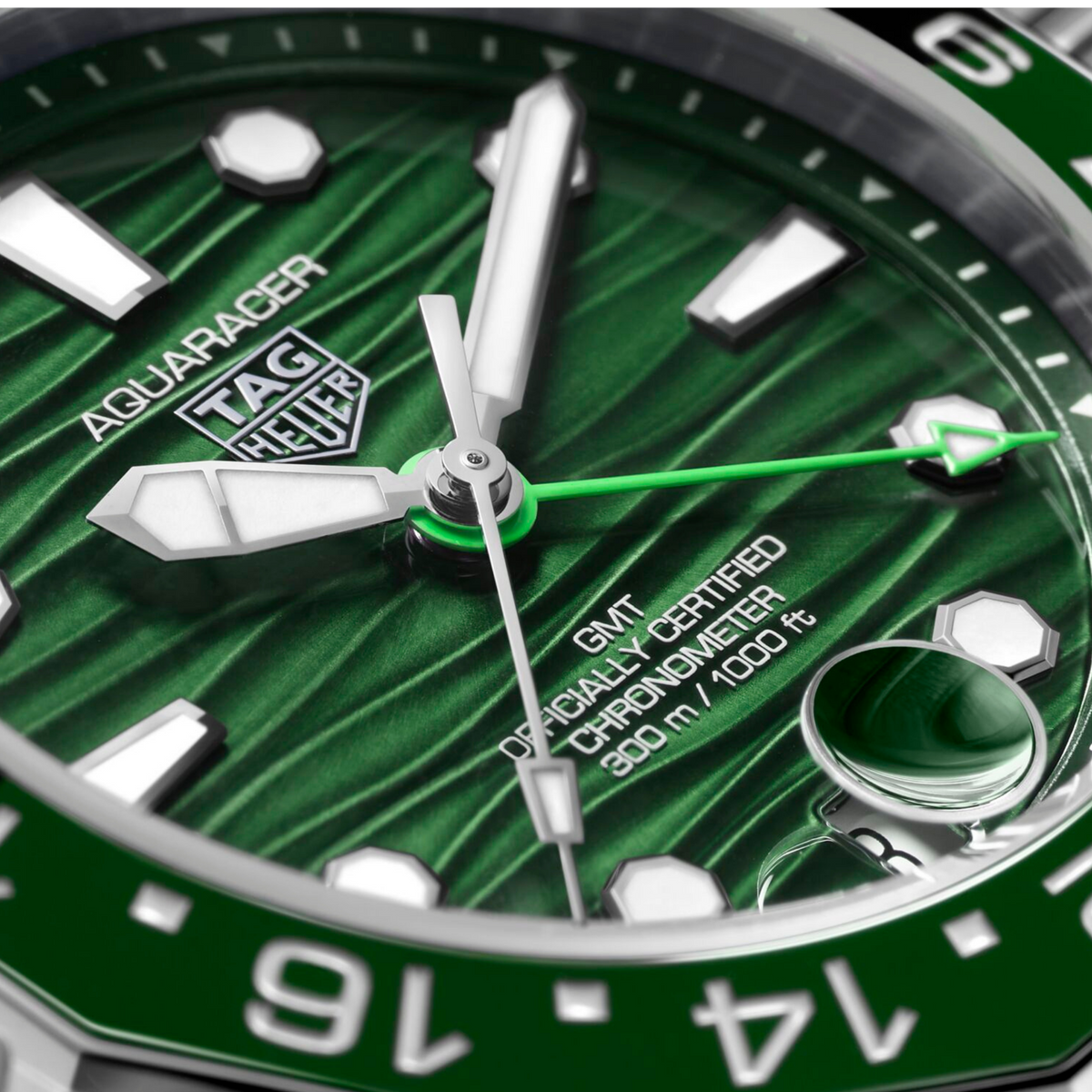 close-up of the textured green dial, highlighting the wave motif, GMT hand, and high-visibility indexes designed for precision and clarity in all lighting conditions