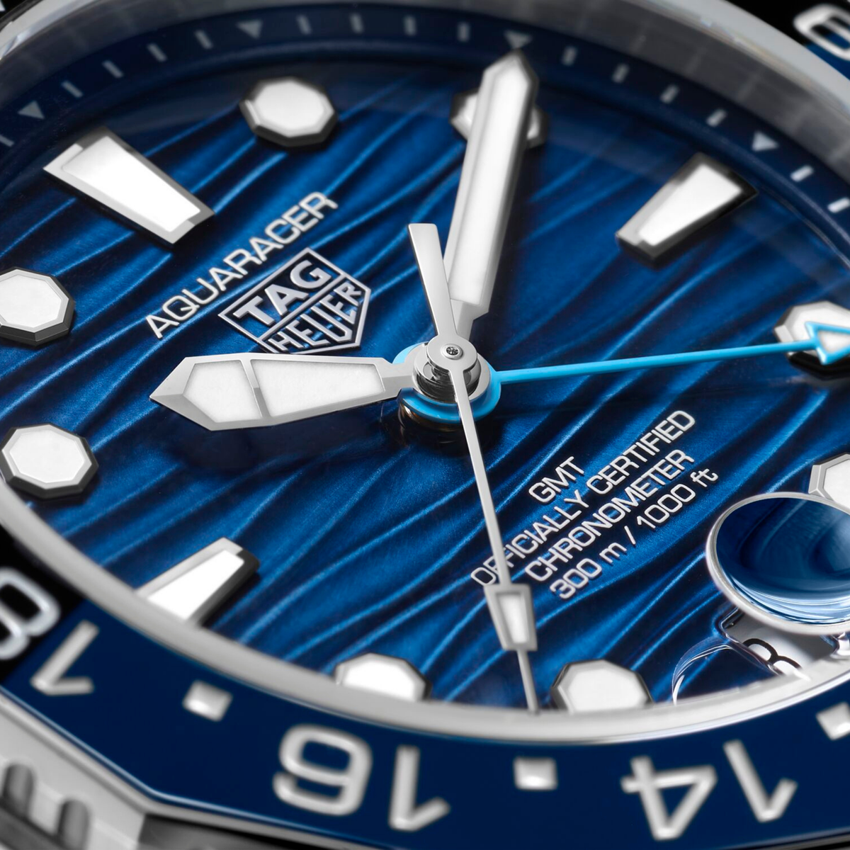 close-up of the textured blue dial, showcasing the distinctive wave motif, GMT hand, and high-contrast indexes designed for clear readability in all conditions