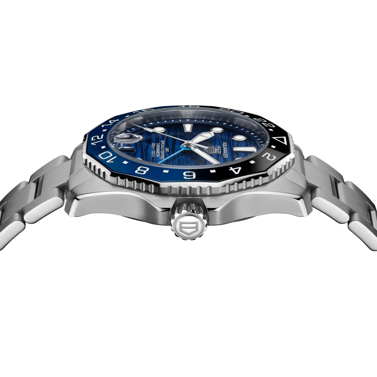 side angle of the case revealing the screw-down crown, unidirectional GMT bezel, and robust build engineered for travel and underwater performance