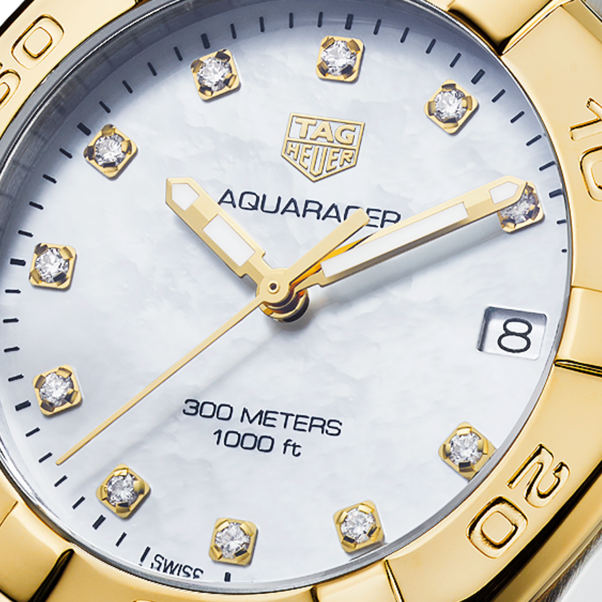 close-up of the mother-of-pearl dial showcasing the diamond-set hour markers, gold-tone hands and date window