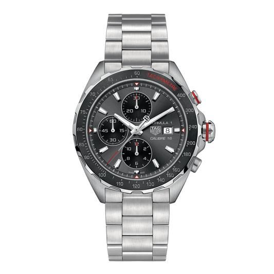 TAG Heuer Formula 1 Calibre 16 chronograph watch with dark grey dial, three sub-dials, tachymetre bezel with red detailing, date window at 3 o’clock, and stainless steel bracelet