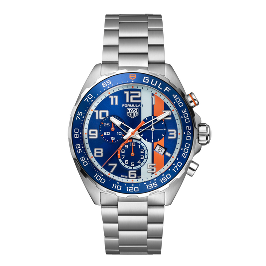 TAG Heuer Formula 1 Gulf chronograph watch with blue dial, signature orange racing stripe, three sub-dials, date window at 4 o’clock, and stainless steel bracelet