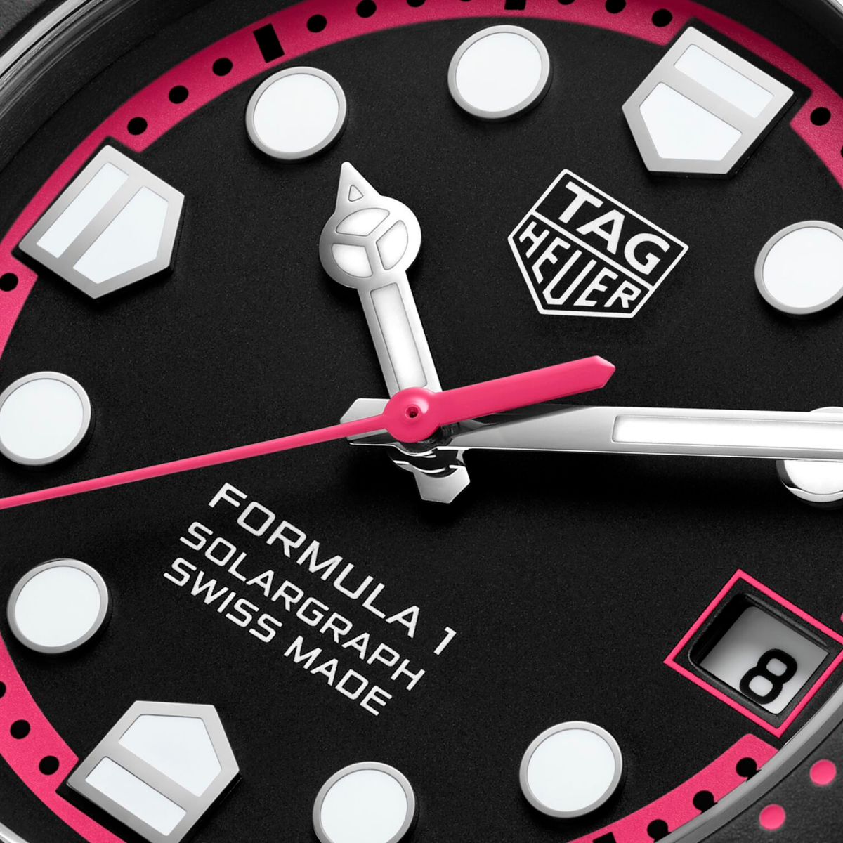 close-up of the black dial highlighting the vibrant pink chapter ring, high-contrast markers and hands for easy readability