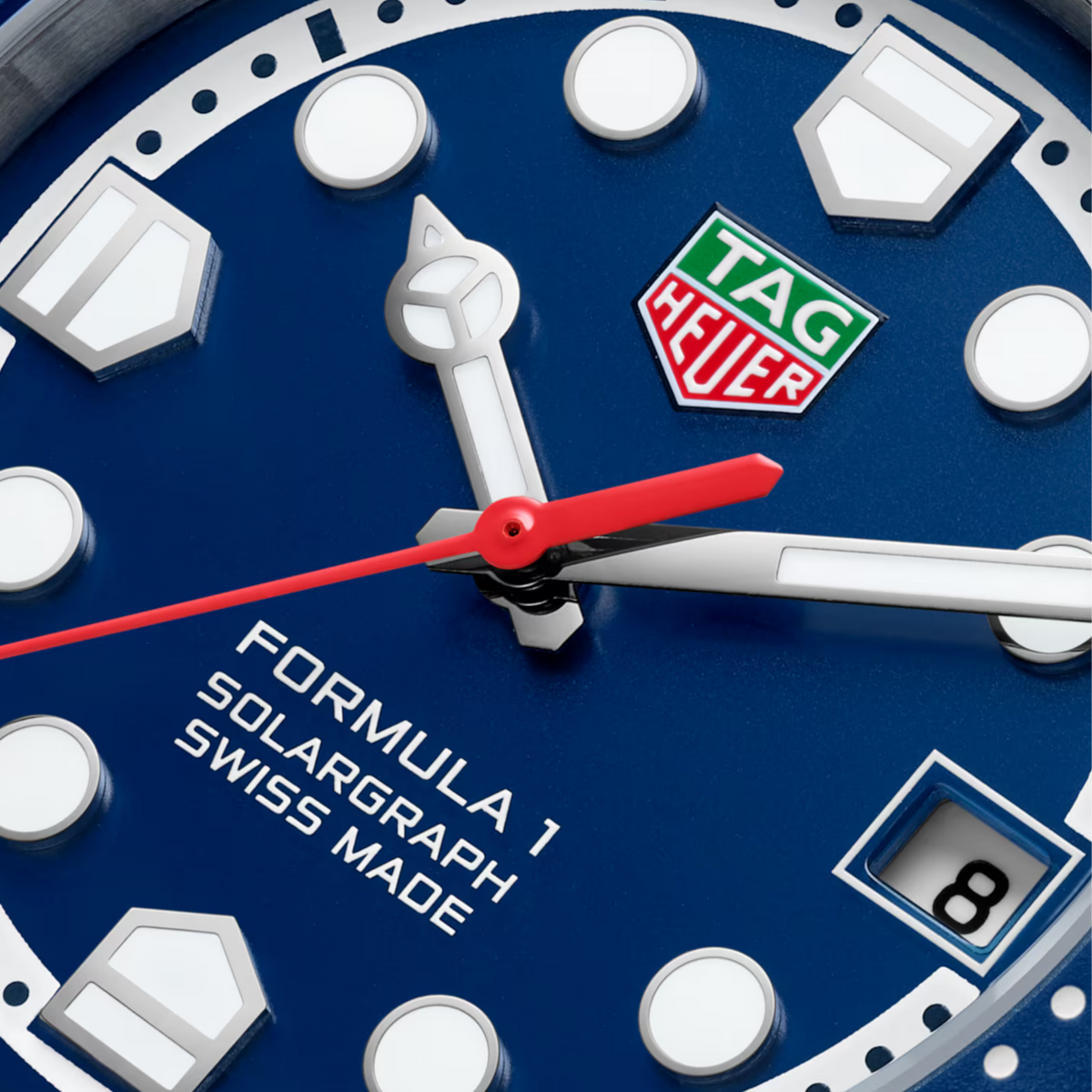 Close-up of the TAG Heuer Formula 1 Solargraph blue dial featuring luminous hour markers and date display.
